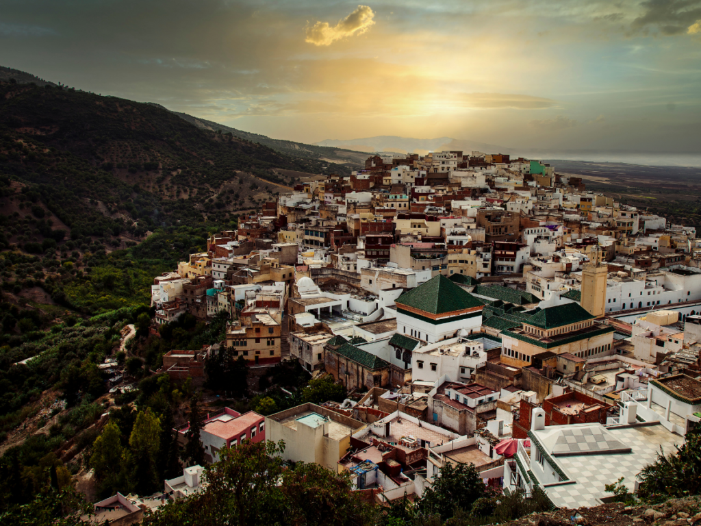 Tourist respectfully dressed visiting a mosque courtyard during a holiday to Morocco