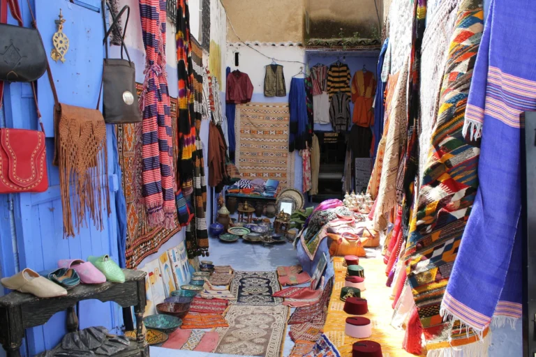 Blue medina lane lined with handwoven textiles
